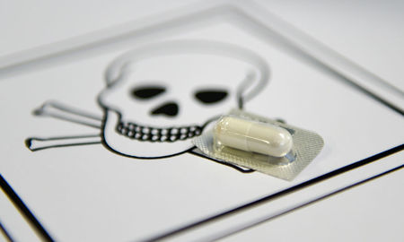 Tablette vor einem Totenkopfsymbol / KNA/Jörg Loeffke